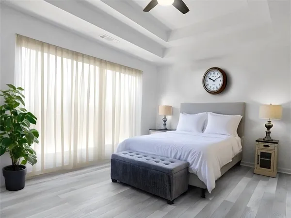a bedroom with a large bed and a potted plant