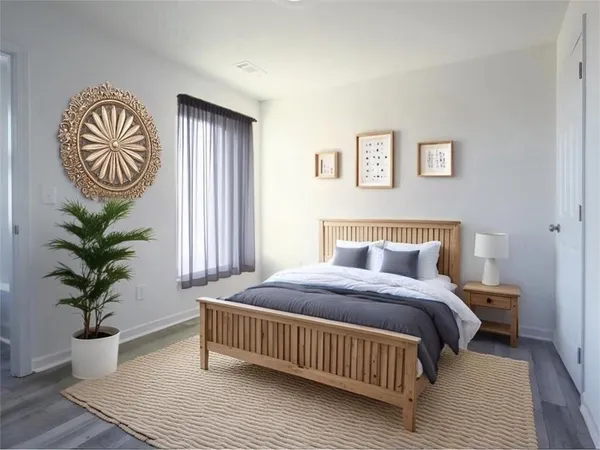 a bedroom with a bed and a potted plant