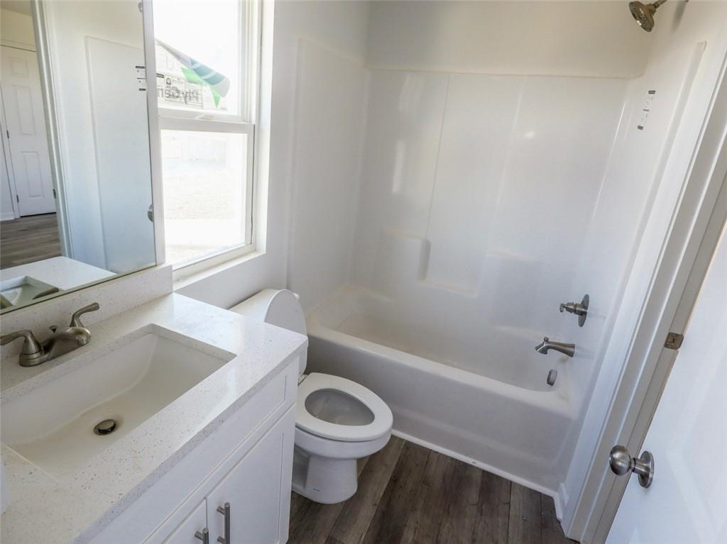 142 Pinto Lane Fairmount, GA 30139 - Photo 18 of 20 a bathroom with a sink a toilet and shower