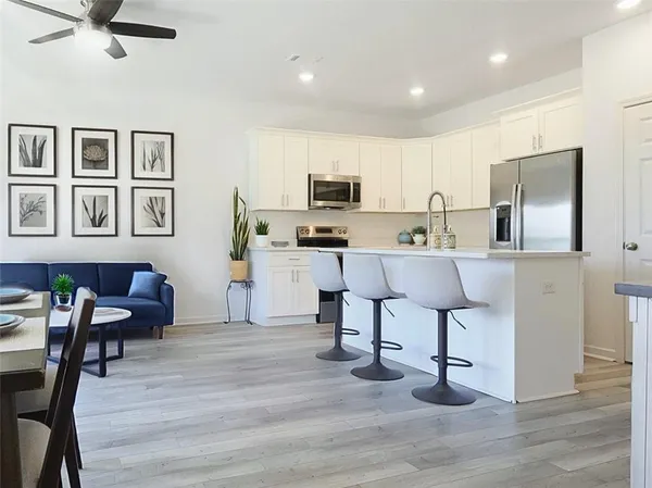 a kitchen with a sink cabinets and wooden floor