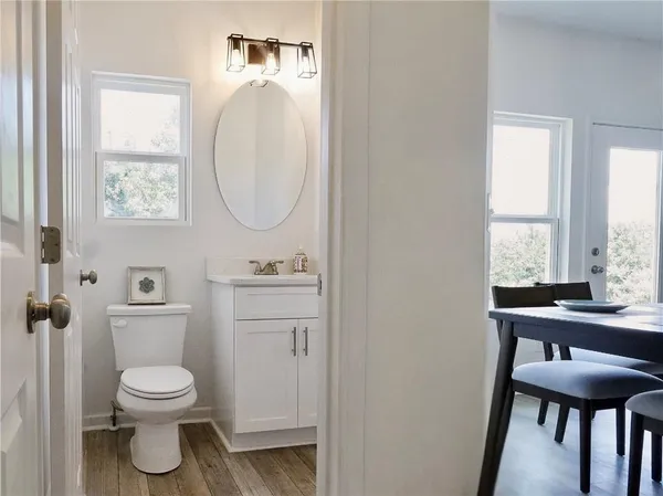 a bathroom with a toilet a sink and a mirror