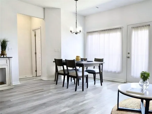 a view of a dining room with furniture and wooden floor