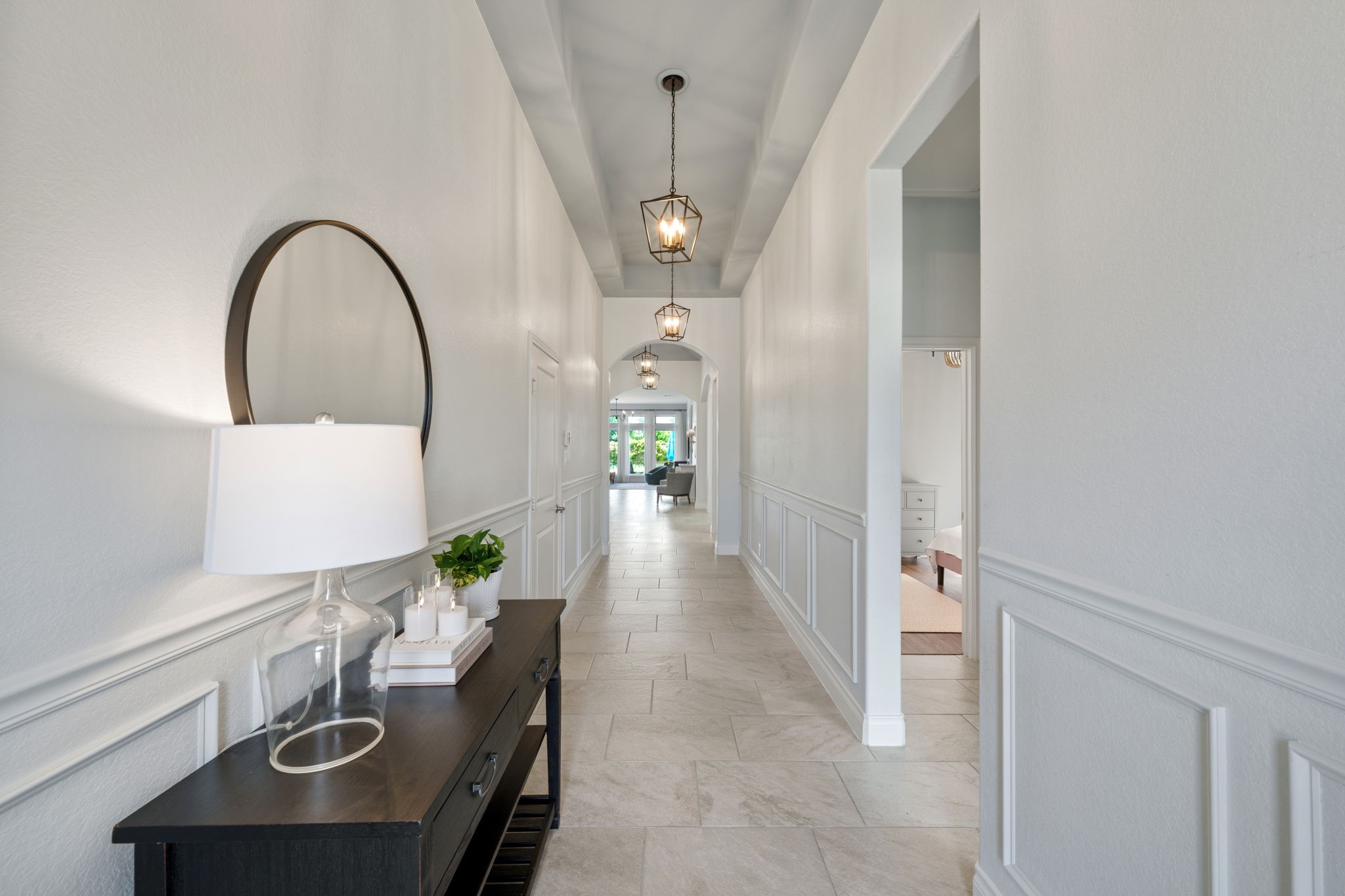 2119 Blackhawk Ridge Lane Manvel, TX 77578 - Photo 4 of 49 A grand, light-filled entry hallway, arched architectural details, and a series of designer pendant lanterns leading you effortlessly into the heart of the home.