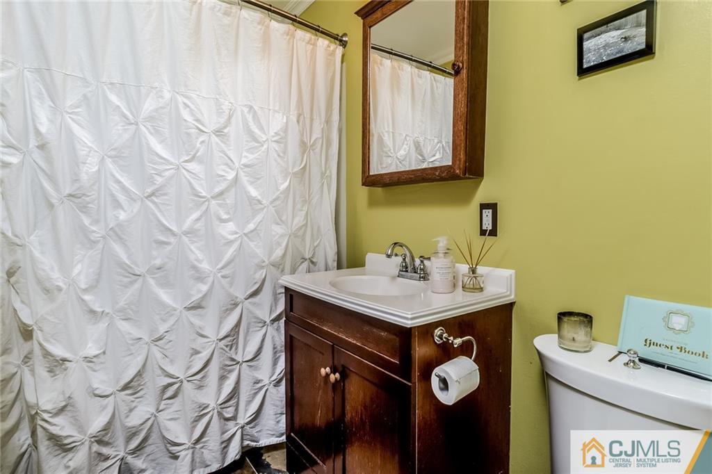34 Wilcox Road New Brunswick, NJ 08901 - Photo 12 of 24 a bathroom with a sink a toilet and a mirror
