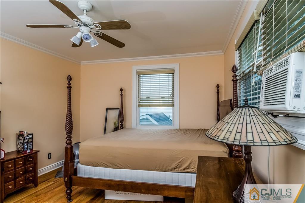 34 Wilcox Road New Brunswick, NJ 08901 - Photo 13 of 24 a bedroom with a bed and a chandelier