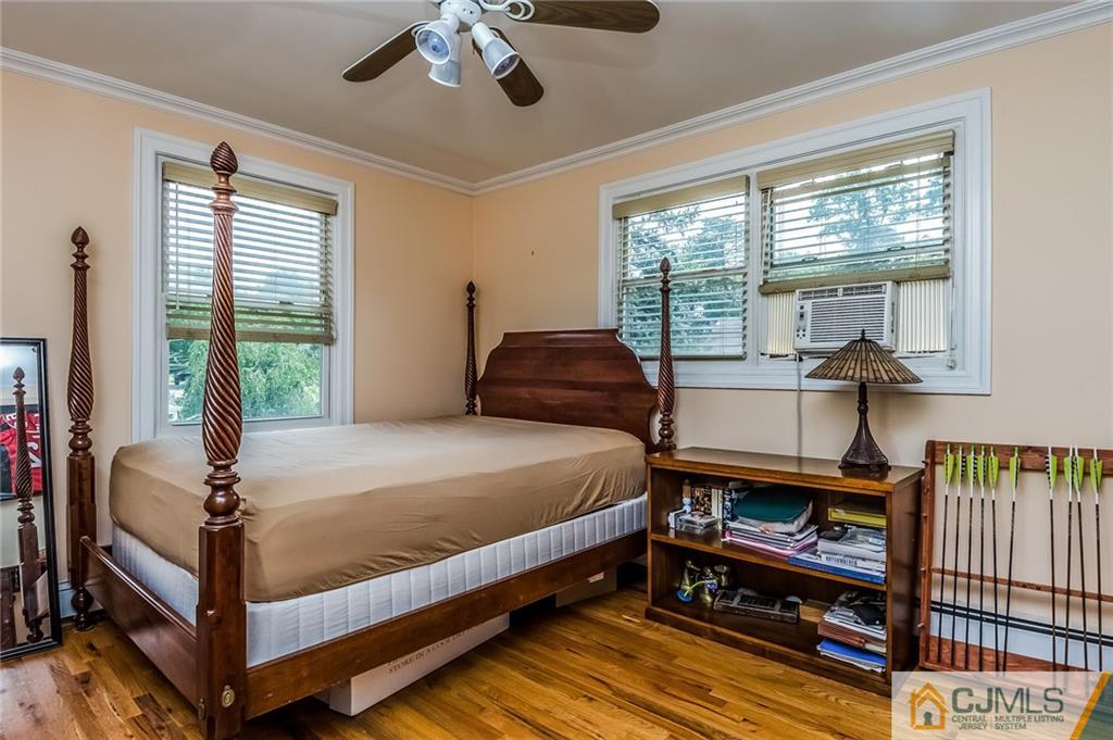 34 Wilcox Road New Brunswick, NJ 08901 - Photo 15 of 24 a bedroom with a bed a flat screen tv and a large window with the outer view