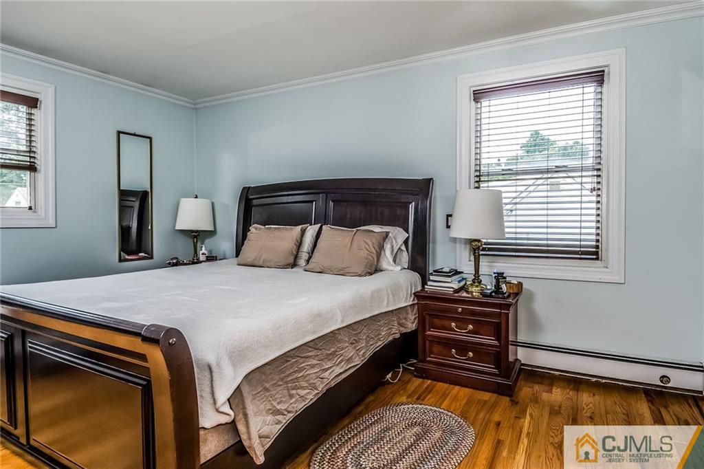 34 Wilcox Road New Brunswick, NJ 08901 - Photo 16 of 24 a bed sitting in a bedroom next to a window