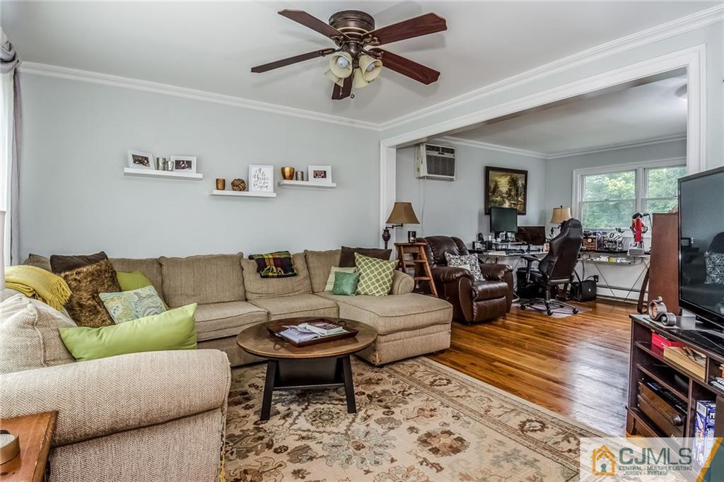 34 Wilcox Road New Brunswick, NJ 08901 - Photo 5 of 24 a living room with furniture a wooden floor and a ceiling fan
