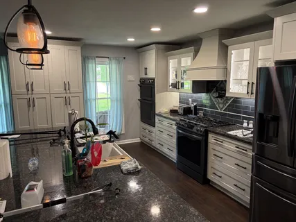 a kitchen with kitchen island granite countertop a stove and a refrigerator