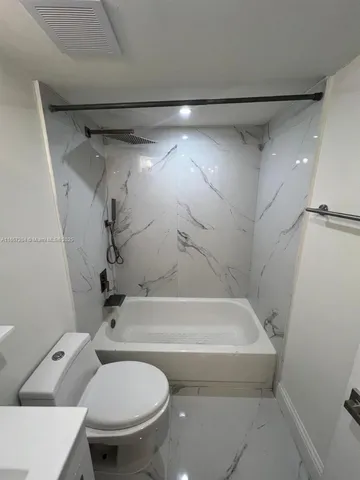 a bathroom with a toilet and a bathtub