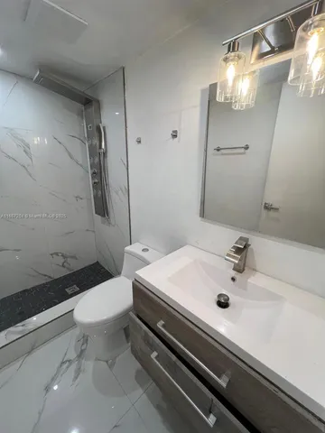 a bathroom with a sink toilet and shower