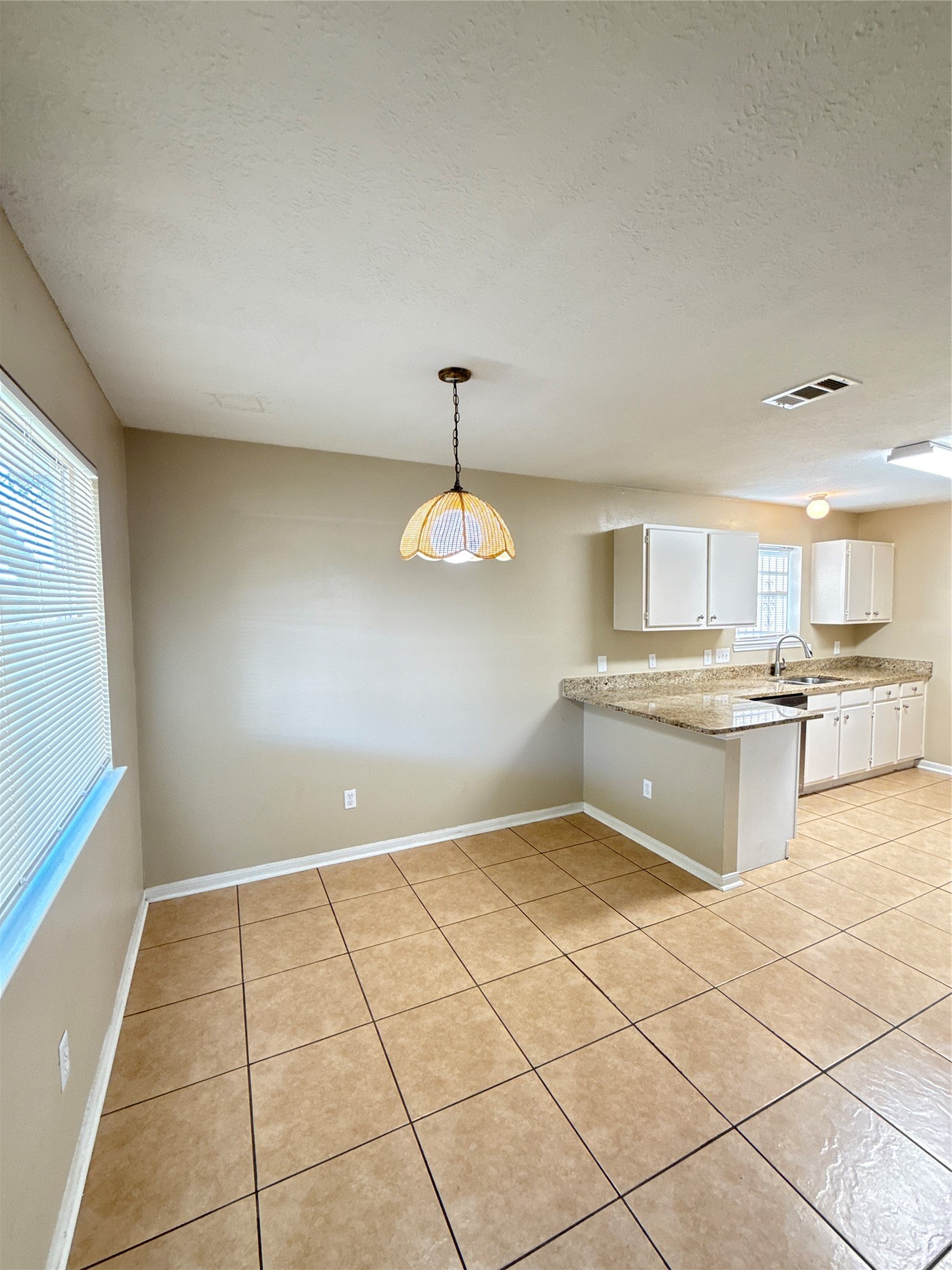 15919 Hiram Clarke Road Houston, TX 77053 - Photo 11 of 29 a kitchen with a sink a counter top space cabinets and appliances