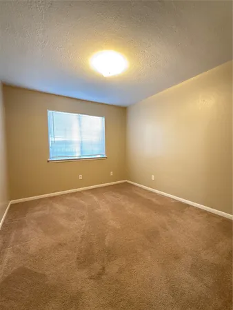 an empty room with a empty space and a window