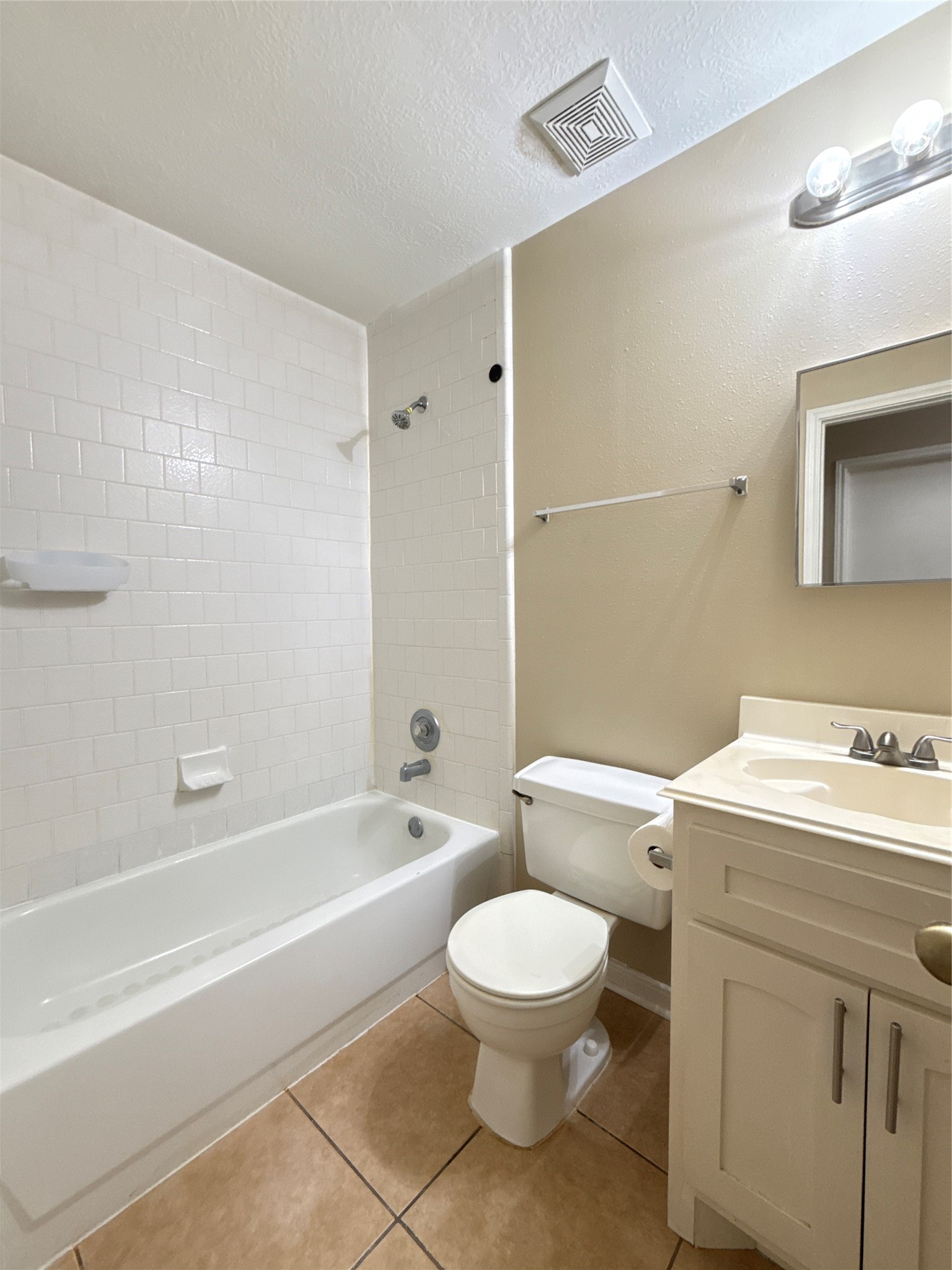 15919 Hiram Clarke Road Houston, TX 77053 - Photo 19 of 29 a bathroom with a toilet a sink a mirror and bathtub