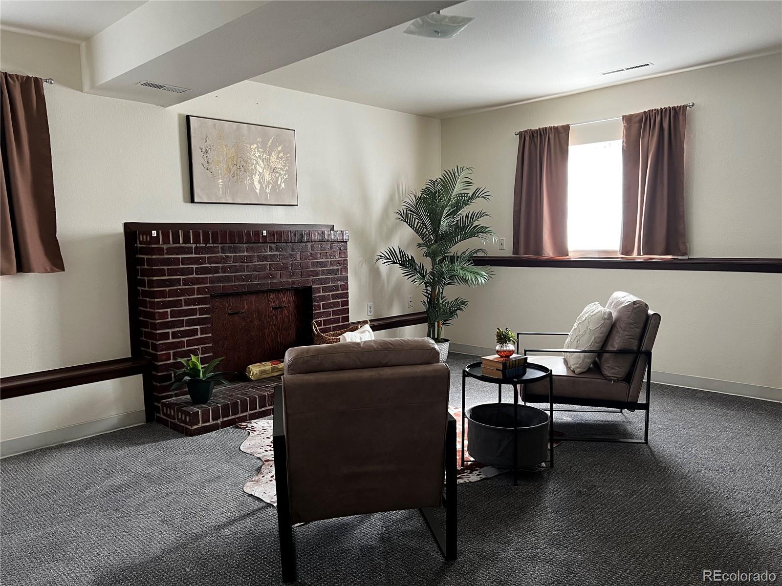 1810 Winnebago Road Colorado Springs, CO 80915 - Photo 11 of 19 a living room with furniture and a fireplace
