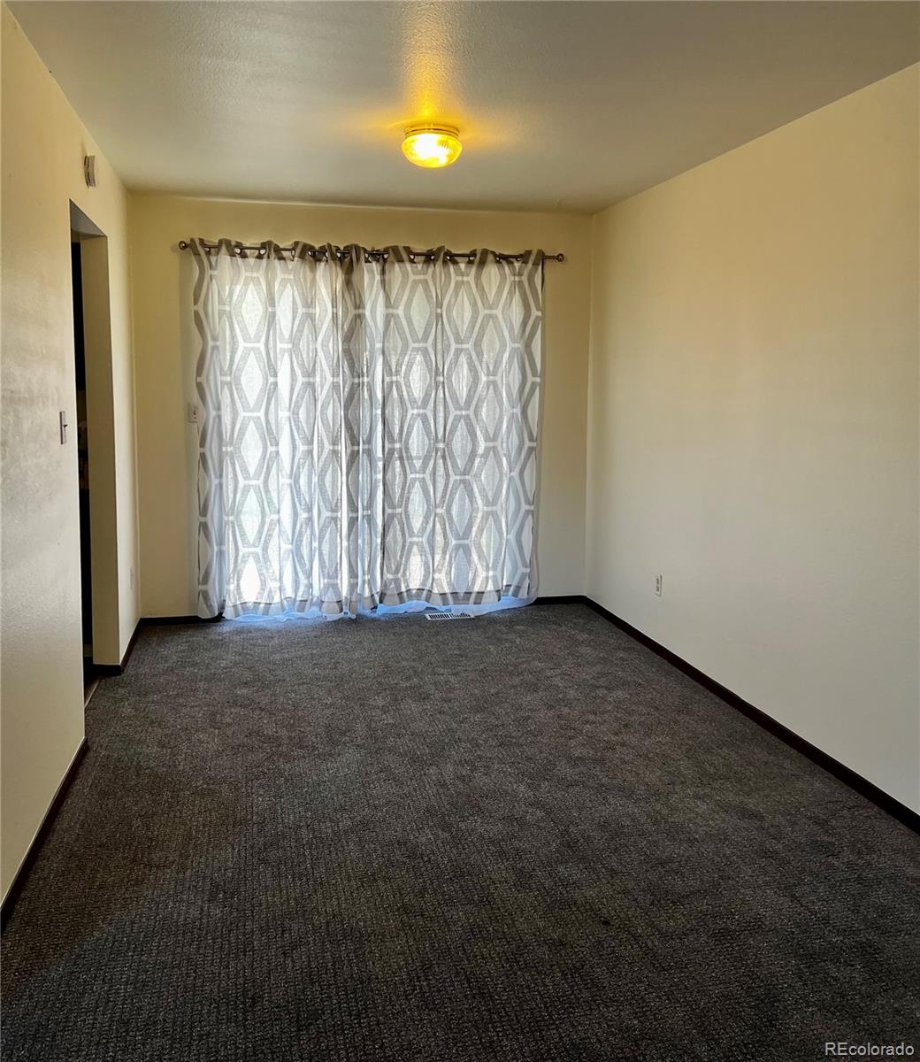 1810 Winnebago Road Colorado Springs, CO 80915 - Photo 12 of 19 an empty room with a natural light