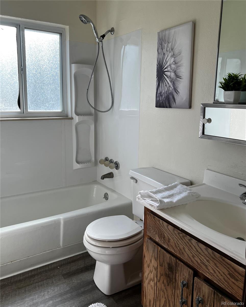 1810 Winnebago Road Colorado Springs, CO 80915 - Photo 14 of 19 a bathroom with a toilet and a bathtub