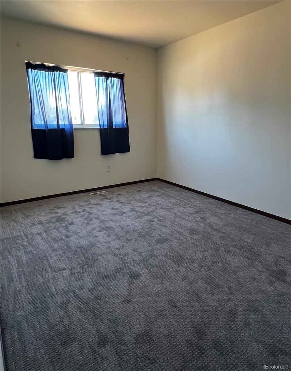1810 Winnebago Road Colorado Springs, CO 80915 - Photo 17 of 19 an empty room with windows