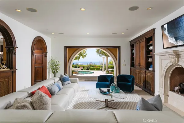 a living room with furniture a fireplace and a large window