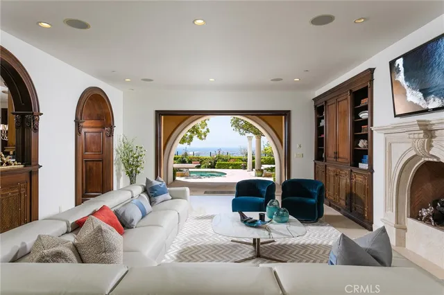 a living room with furniture a fireplace and a large window