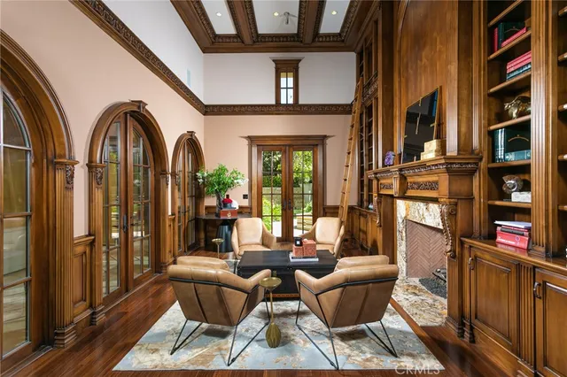 a living room with fireplace furniture and a potted plant