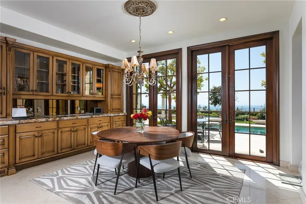 a dining room with furniture a chandelier and wooden floor