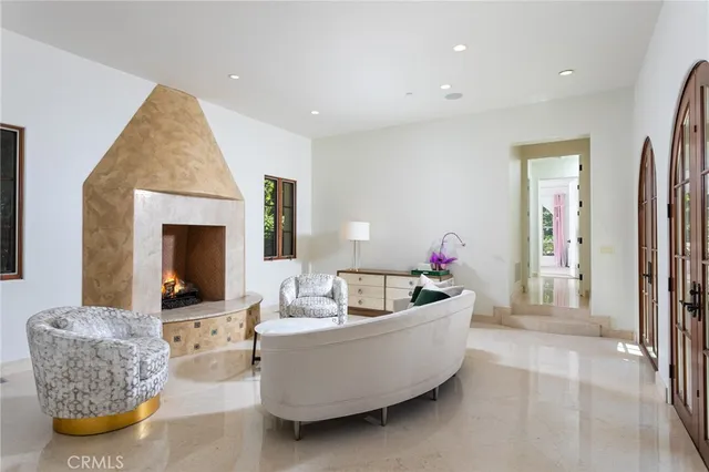 a bedroom with a bed and a lamp on dresser