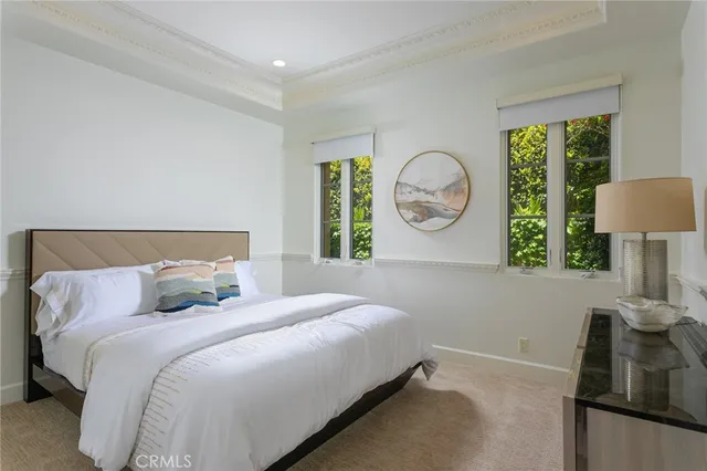 a bedroom with a bed and a large window