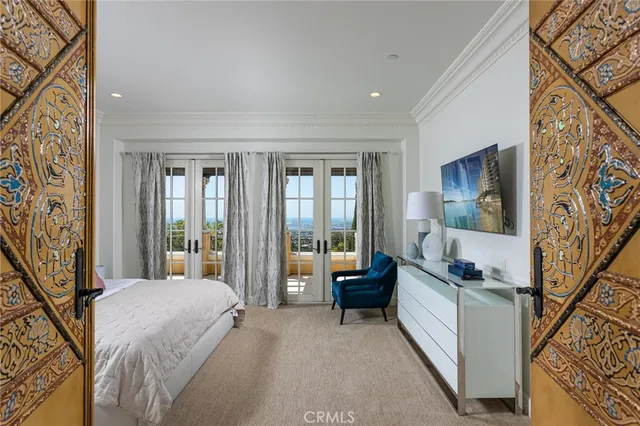 a bedroom with a bed and glass door