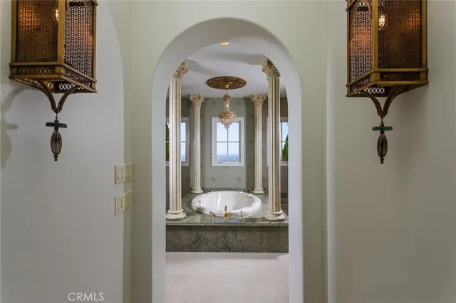 a bathroom with a granite countertop sink mirror and bathtub
