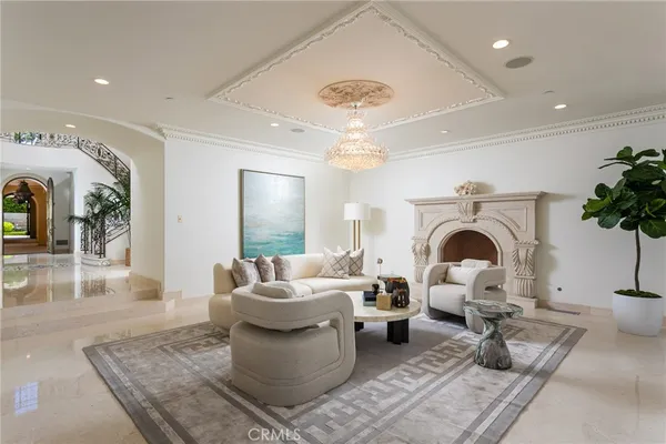 a living room with furniture a rug and a fireplace