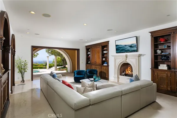 a living room with furniture fireplace and flat screen tv