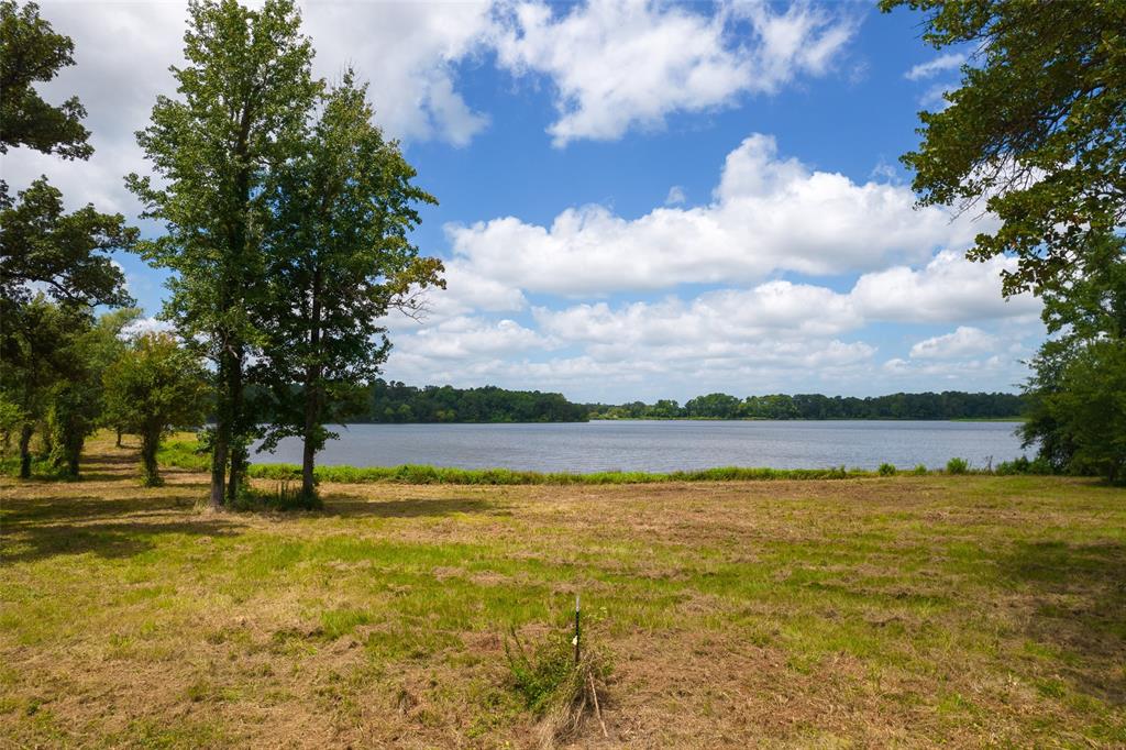 Lot 5-tbd Lot 5-tbd Carolina Way Mount Mount Pleasant, TX 75455 - Photo 8 of 12 a view of a lake with houses in the back