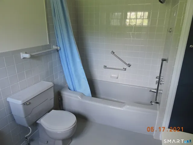 a bed sitting in a room next to a window