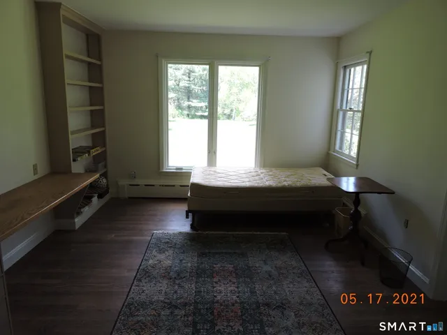 a living room with a wooden floor and a table