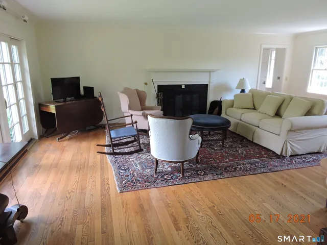 a living room with a couch a window and a flat screen tv