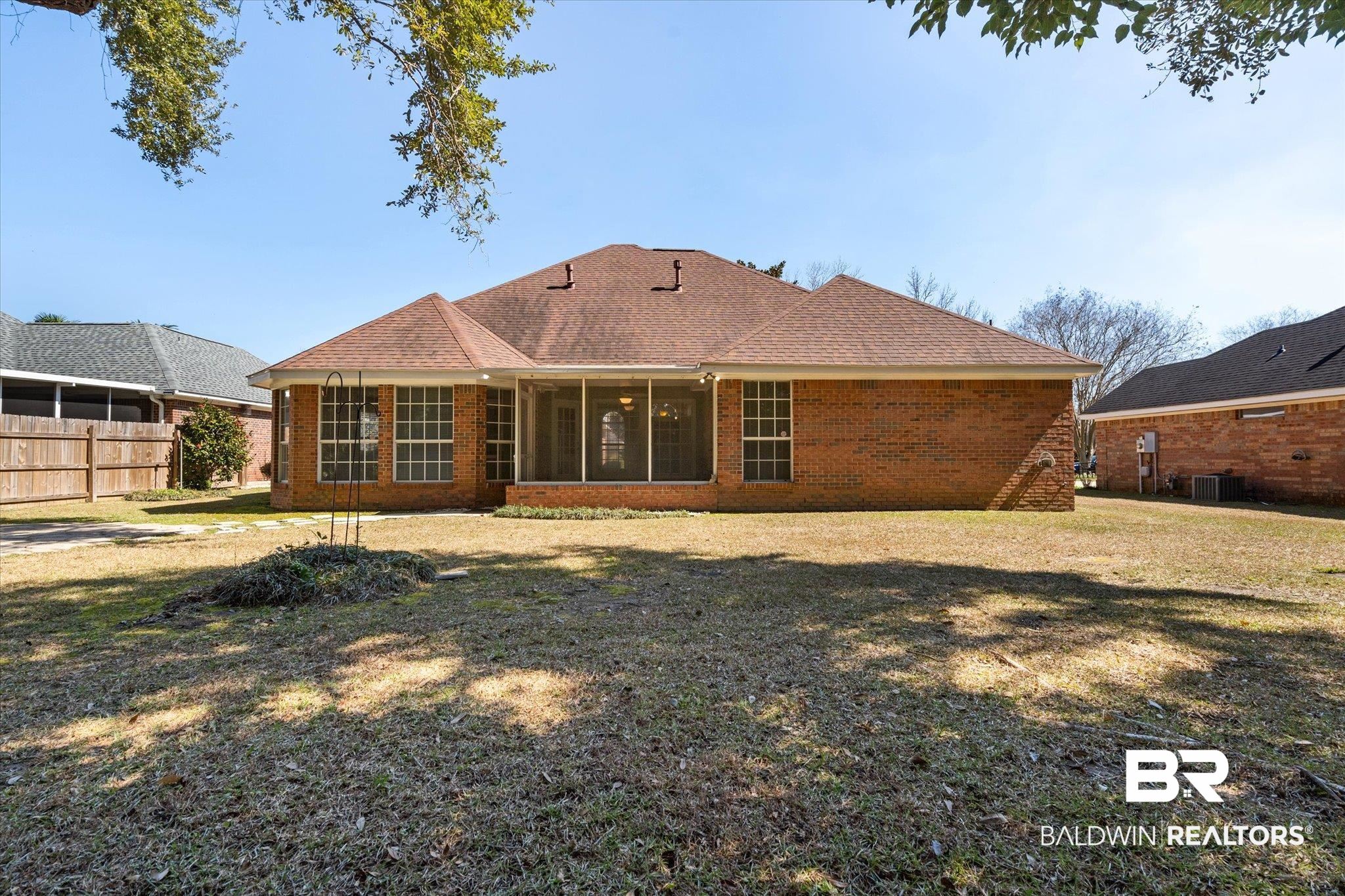 2220 Irongate Court Mobile, AL 36695 - Photo 19 of 20 Back of house featuring a sunroom, fence, a yard, central air condition unit, and brick siding