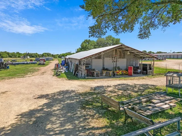 a view of a house with pool and a yard