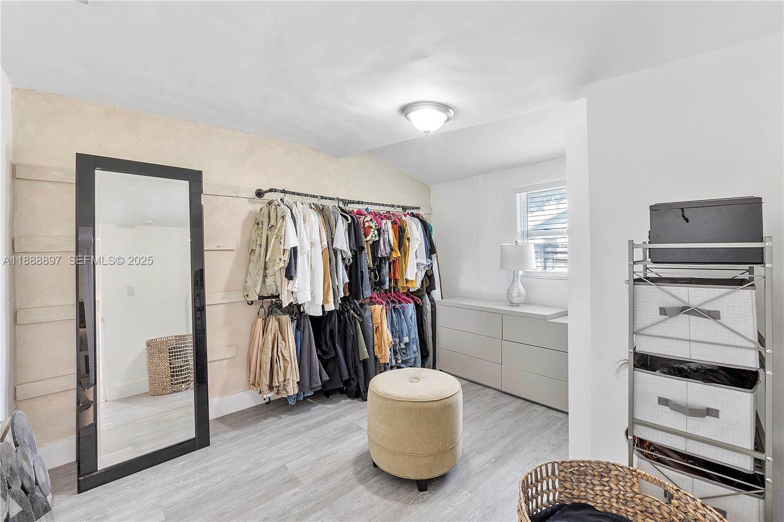 1101 Northwest 40th Street Miami, FL 33127 - Photo 11 of 31 a walk in closet with view of bedroom and bathroom