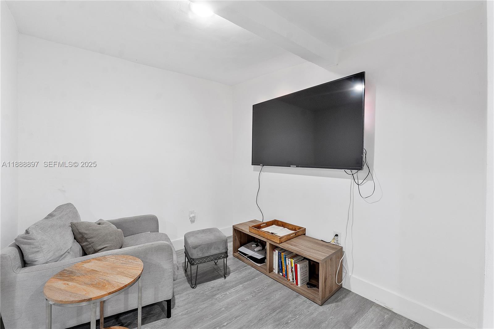 1101 Northwest 40th Street Miami, FL 33127 - Photo 17 of 31 a living room with furniture and a flat screen tv