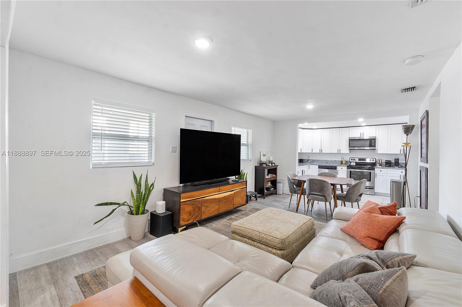 1101 Northwest 40th Street Miami, FL 33127 - Photo 2 of 31 a living room with furniture and a flat screen tv