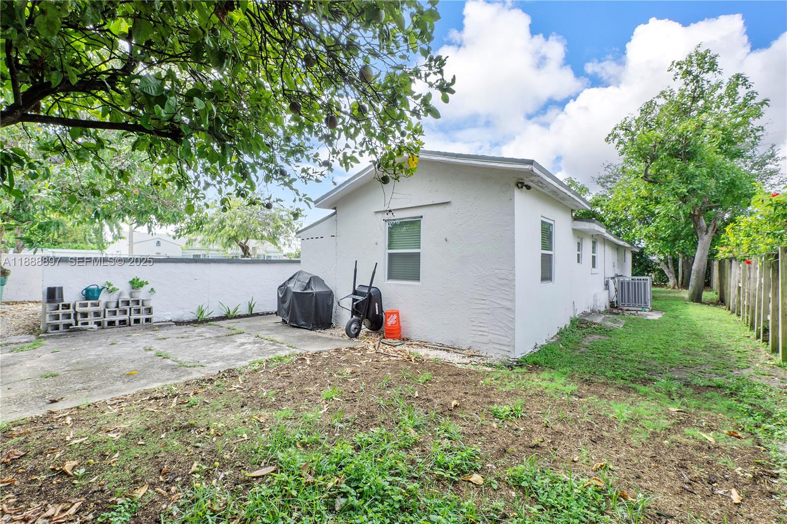 1101 Northwest 40th Street Miami, FL 33127 - Photo 24 of 31 a view of a house with backyard and a tree
