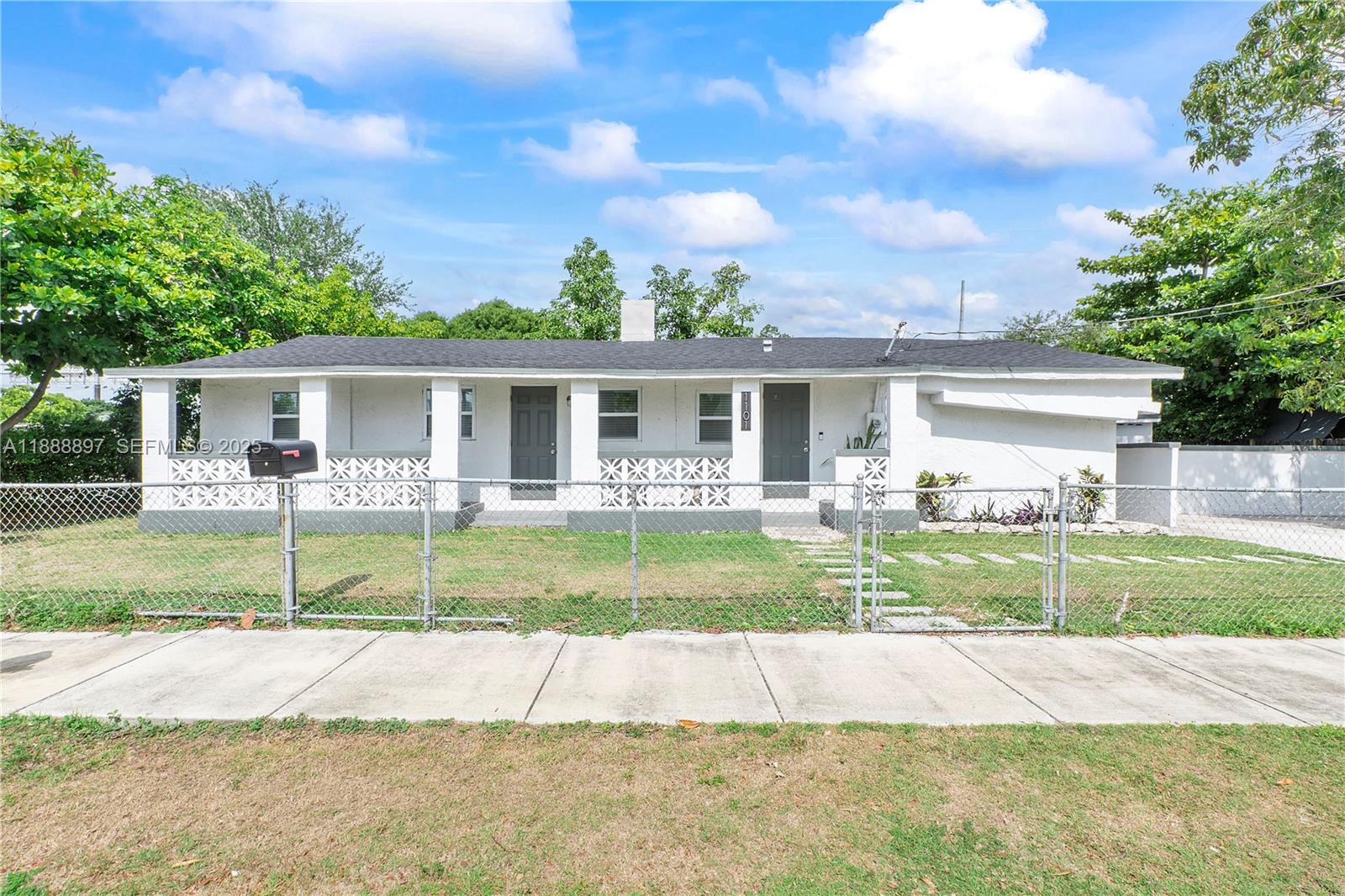 1101 Northwest 40th Street Miami, FL 33127 - Photo 29 of 31 a view of house that has a yard