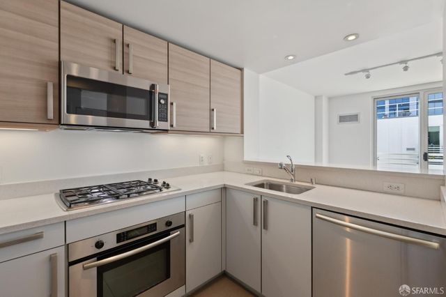 a kitchen with a sink stove and cabinets