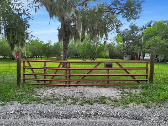 a view of a wooden bench sitting in a yard