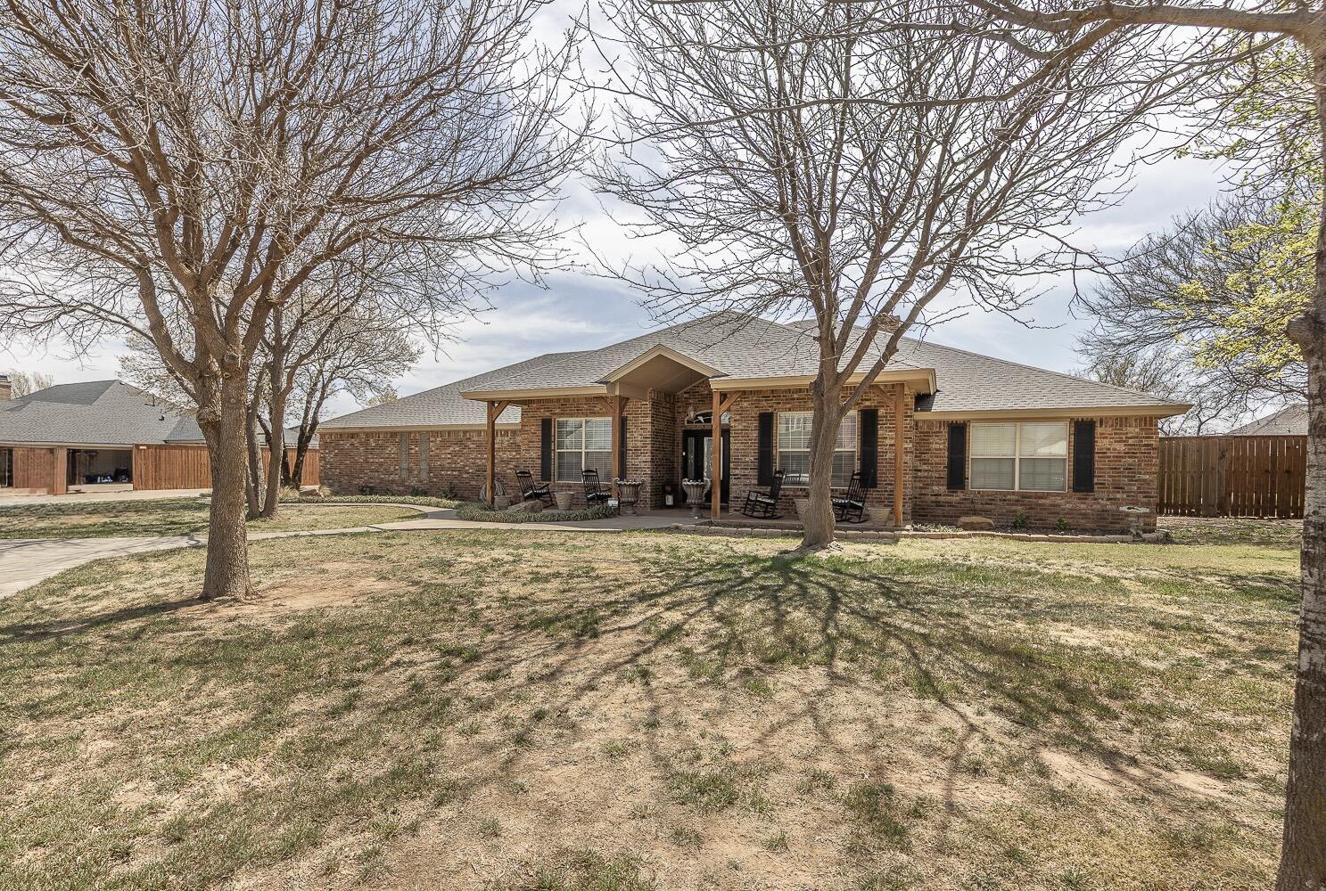 a front view of a house with a yard covered in snow