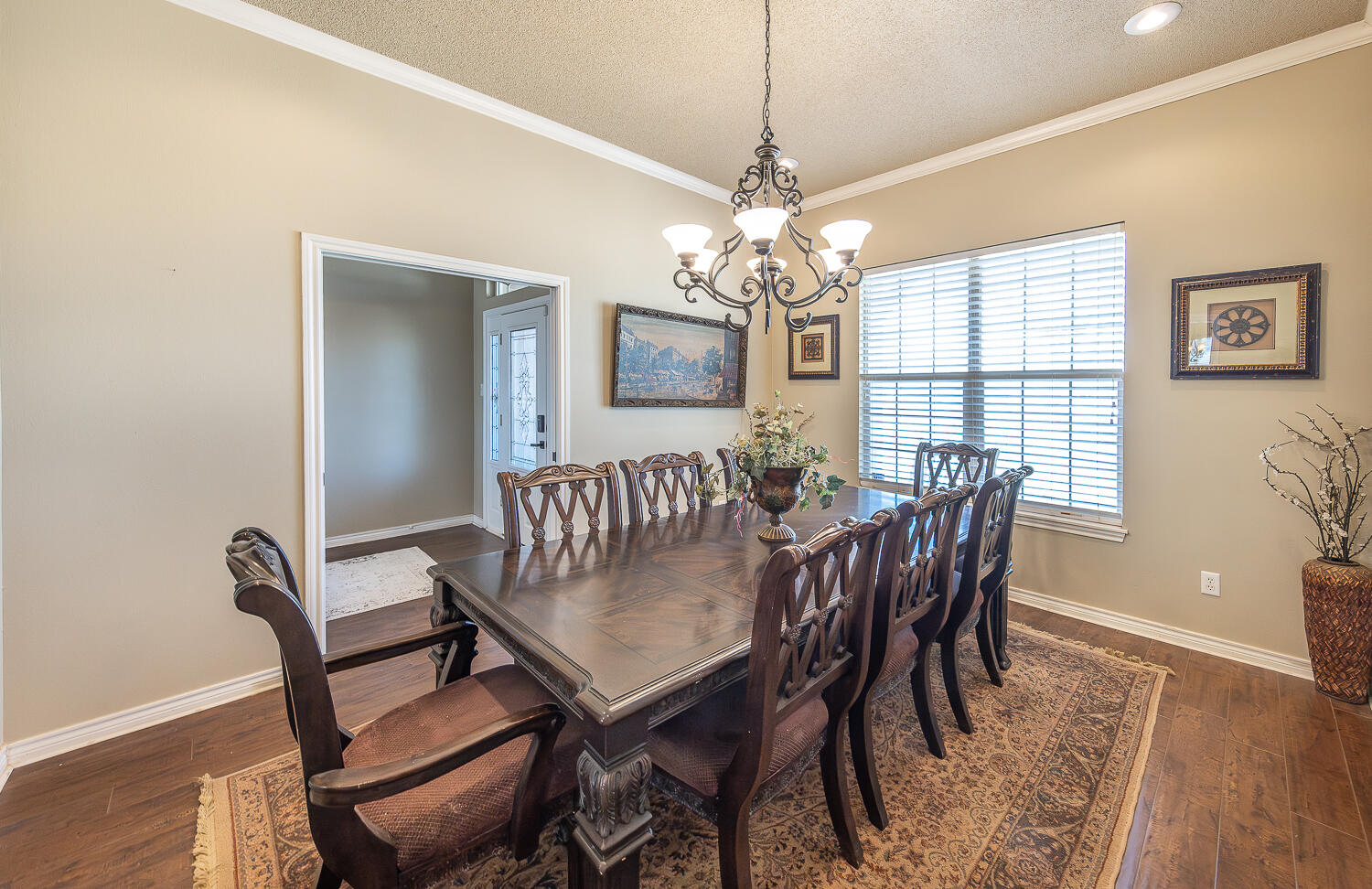 6309 County Road 7470 Lubbock, TX 79424 - Photo 14 of 41 a view of a dining room with furniture wooden floor and chandelier