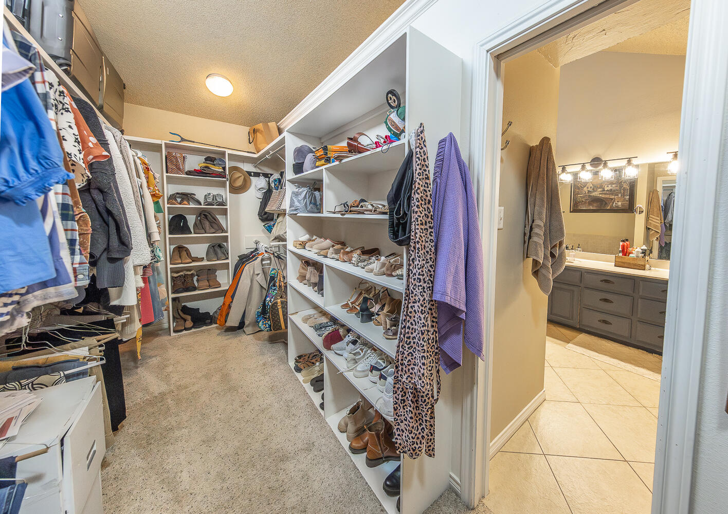 6309 County Road 7470 Lubbock, TX 79424 - Photo 20 of 41 a view of walk in closet with clothes and shoes
