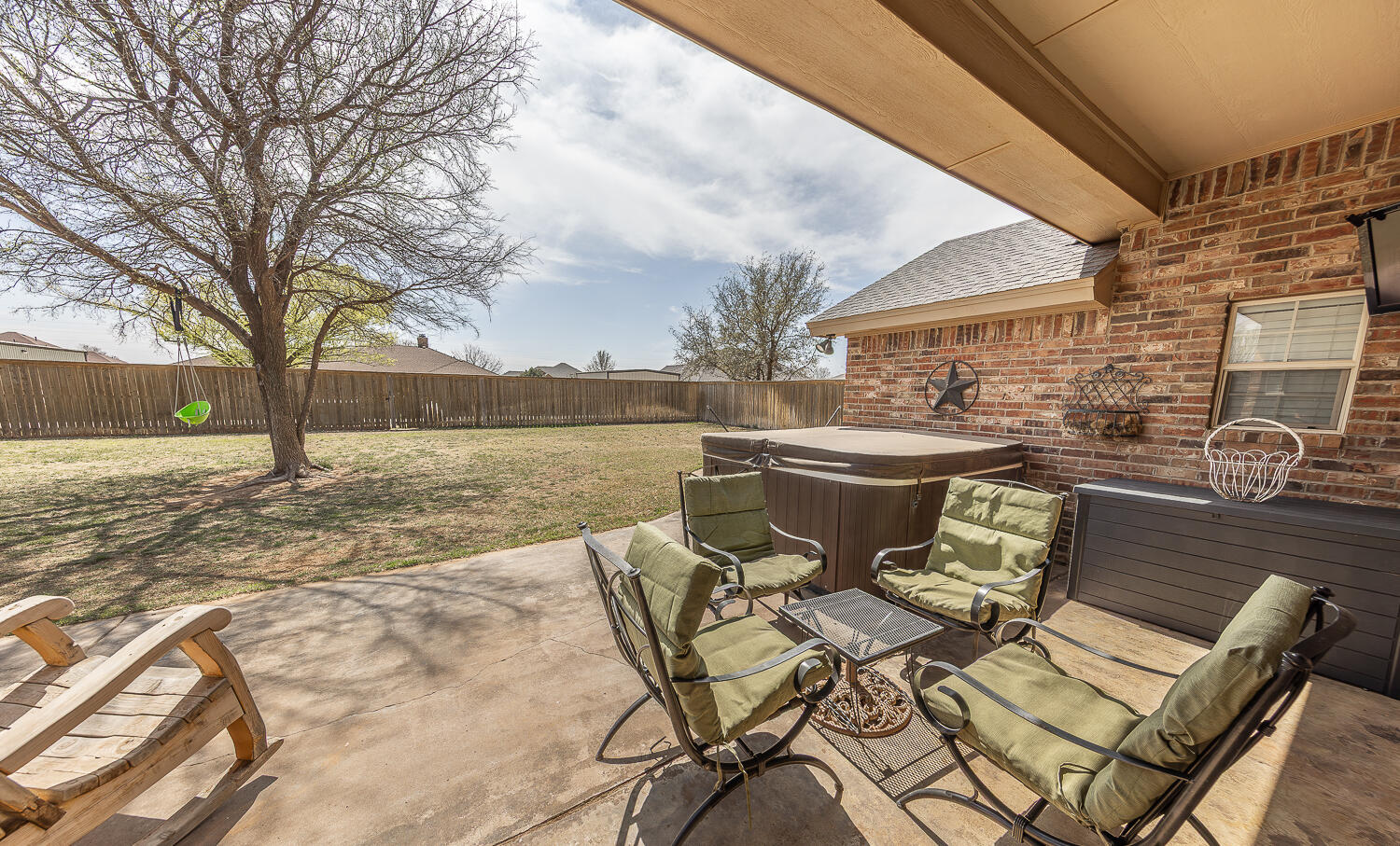 6309 County Road 7470 Lubbock, TX 79424 - Photo 28 of 41 a view of a patio with dining table and chairs with wooden floor and fence