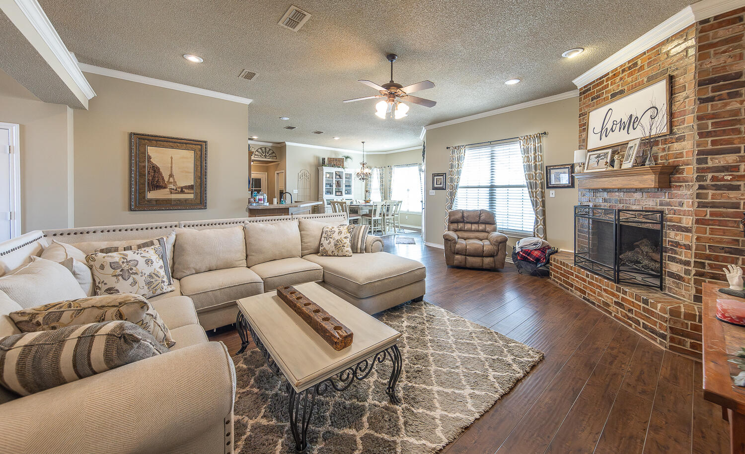 6309 County Road 7470 Lubbock, TX 79424 - Photo 3 of 41 a living room with furniture a fireplace and wooden floor